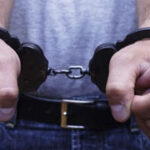 Close-up image of handcuffed fists indicating arrest for dangerous offenses in Arizona.