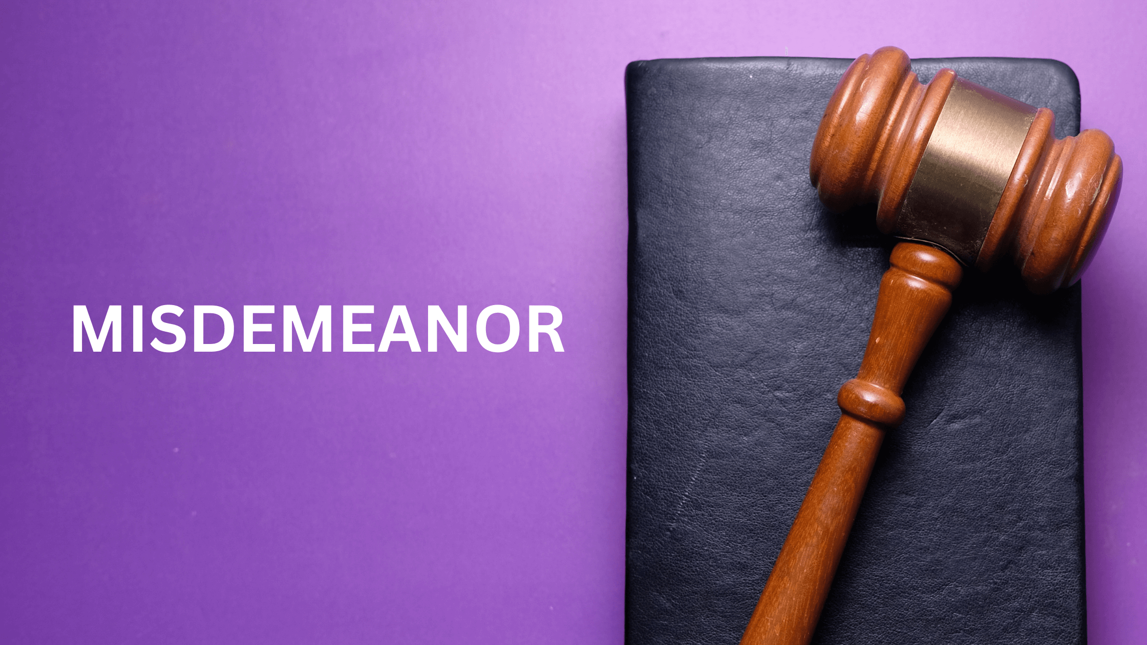 Legal gavel on book, purple background, MISDEMEANOR in white text.