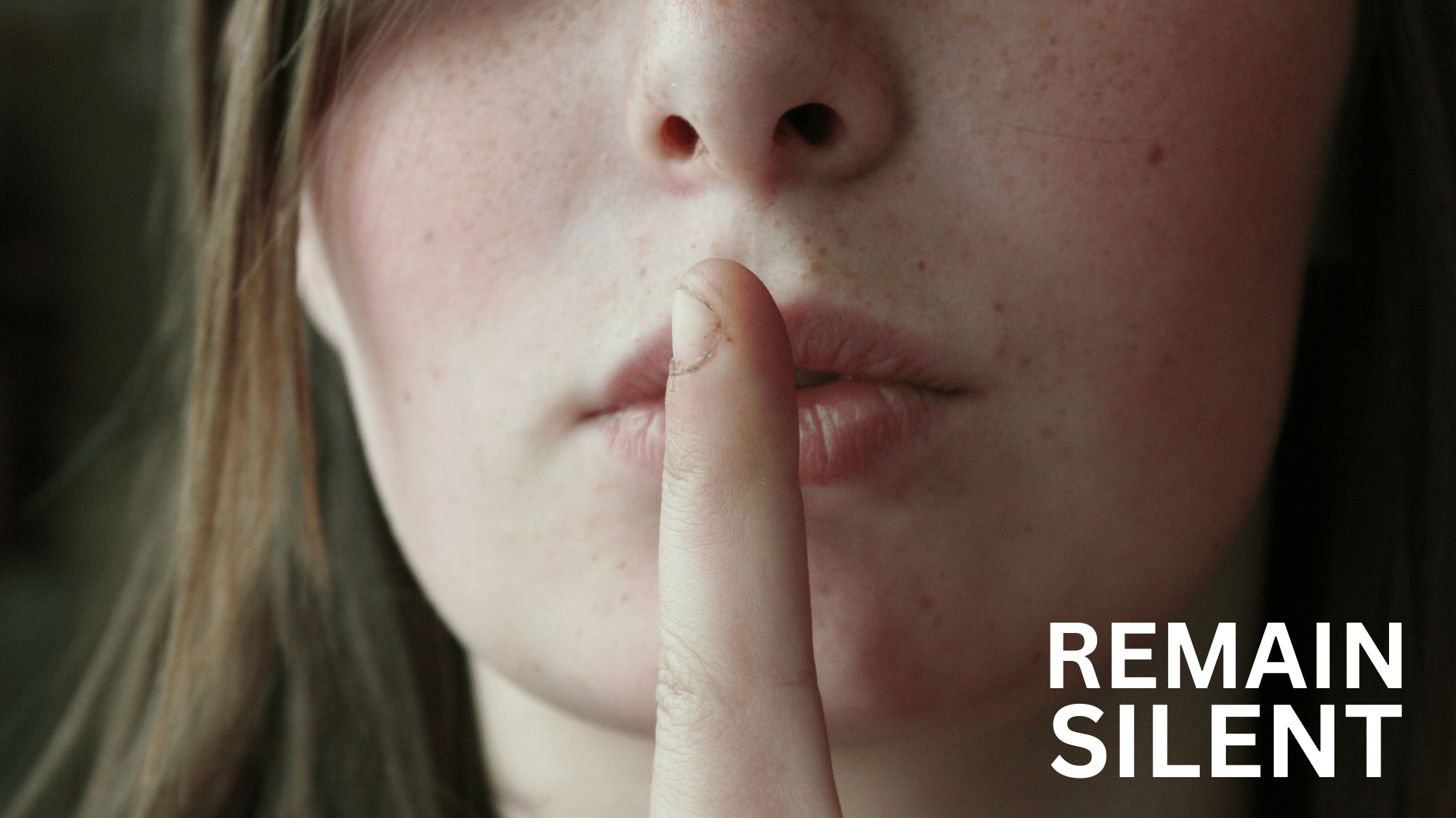 Young woman making shush gesture with REMAIN SILENT text overlay.